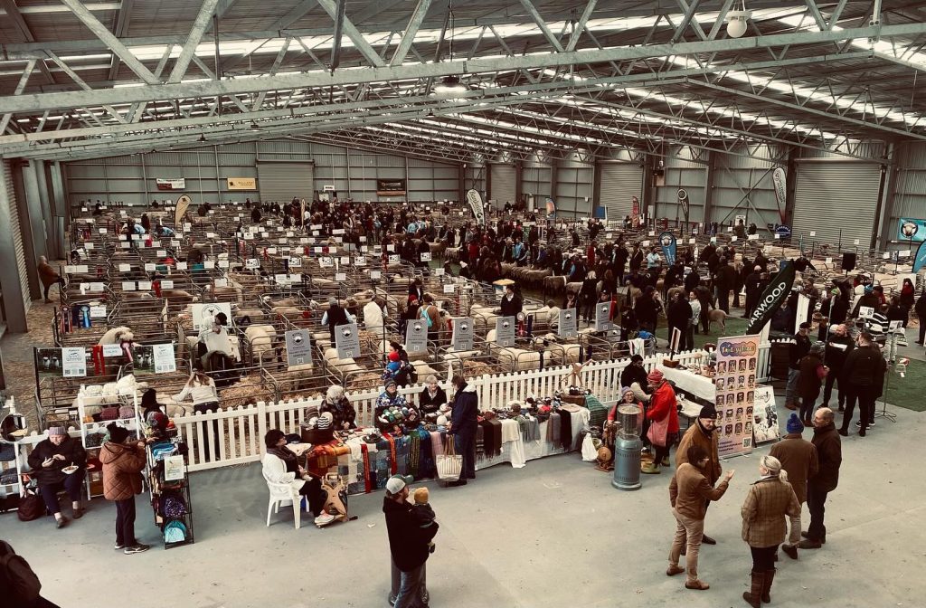 Sheep exhibition hall with crowds and stalls in Australia.